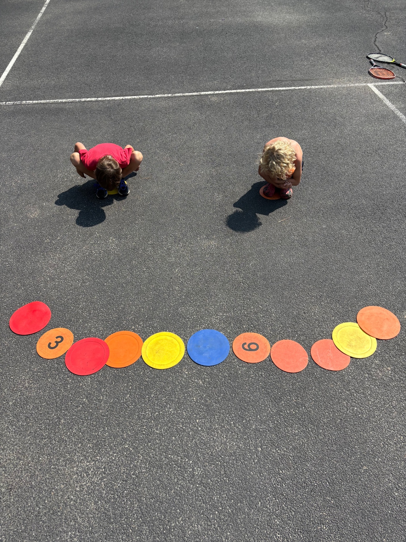 Young athletes training with agility markers on a Hamptons tennis court
